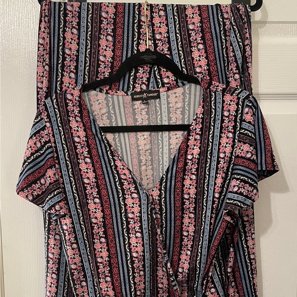 Two piece pink and black pant set.